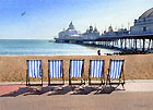 A painting of by deck chairs on the seafront and Eastbourne Pier by Margaret Heath.